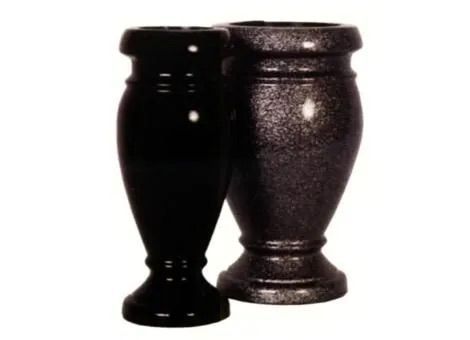 Two black decorative vases standing side by side on a white background