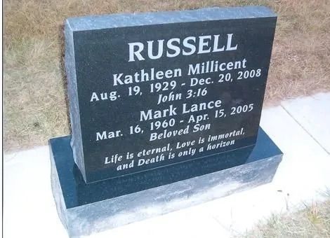 Black granite memorial headstone for Russell and Martha Millicent in a cemetery
