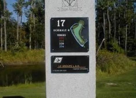 Signpost at a race course showing hole 17 and a course map beside a wooded area.