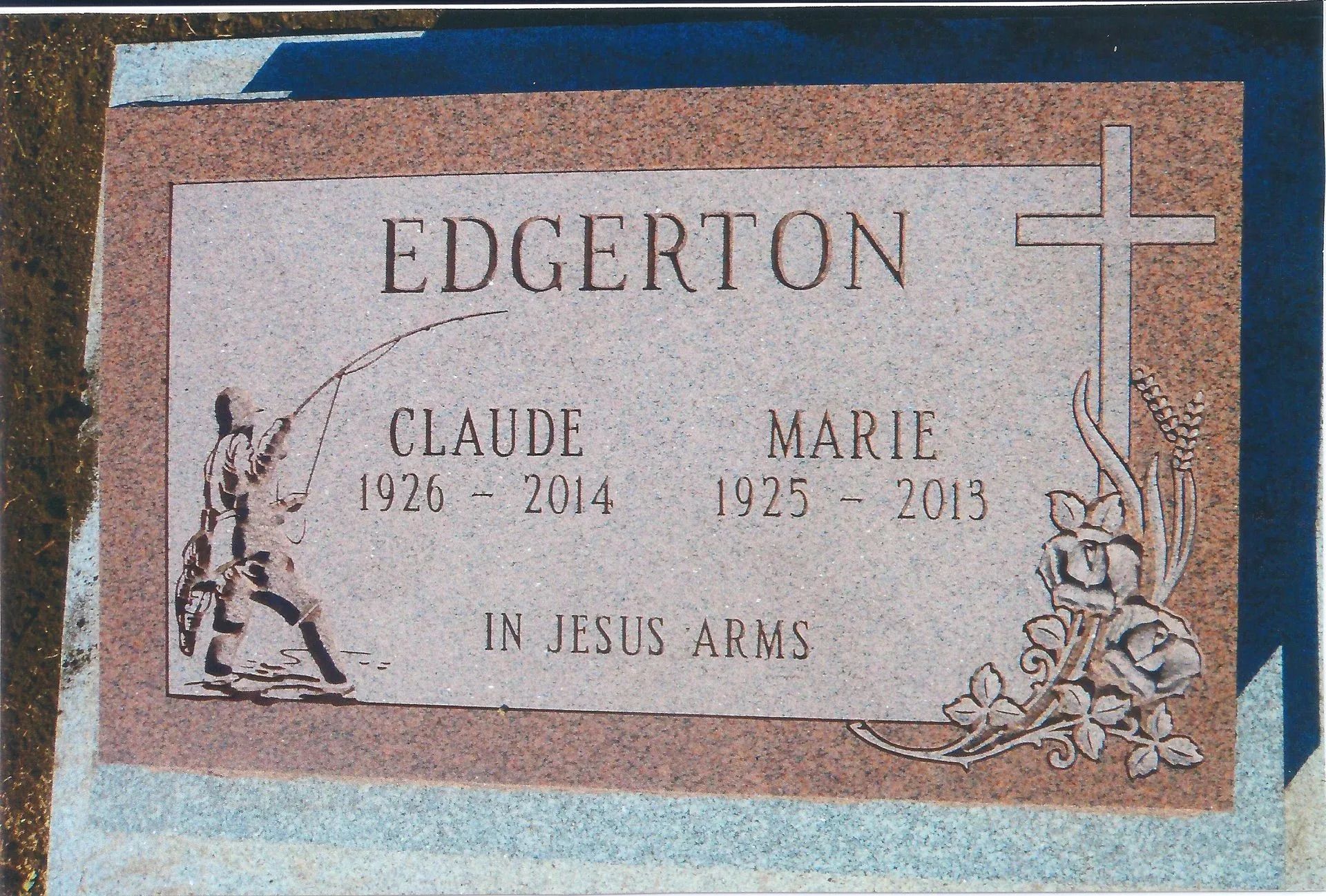 Granite headstone with inscription 'EDGERTON' listing Claude (1926-2014) and Marie (1925-2013), decorated with floral motifs