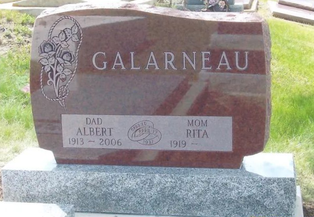 Galarneau gravestone with floral engraving and memorial plaques in a cemetery