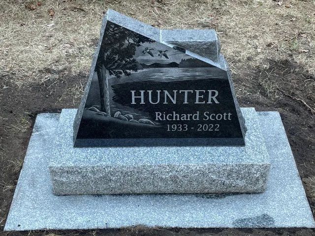 Granite gravestone with “HUNTER” and “Richard Scott 1933–2022” on a concrete base