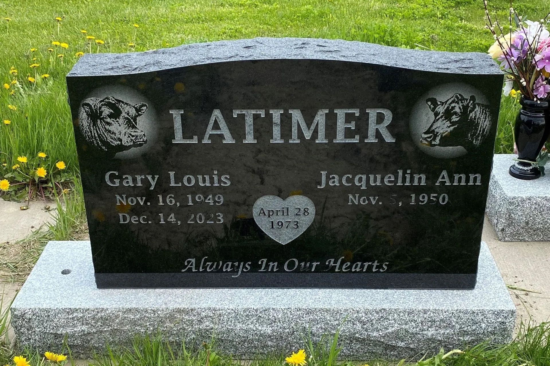 Limer family gravestone with engraved names, black stone and angel motif in a cemetery