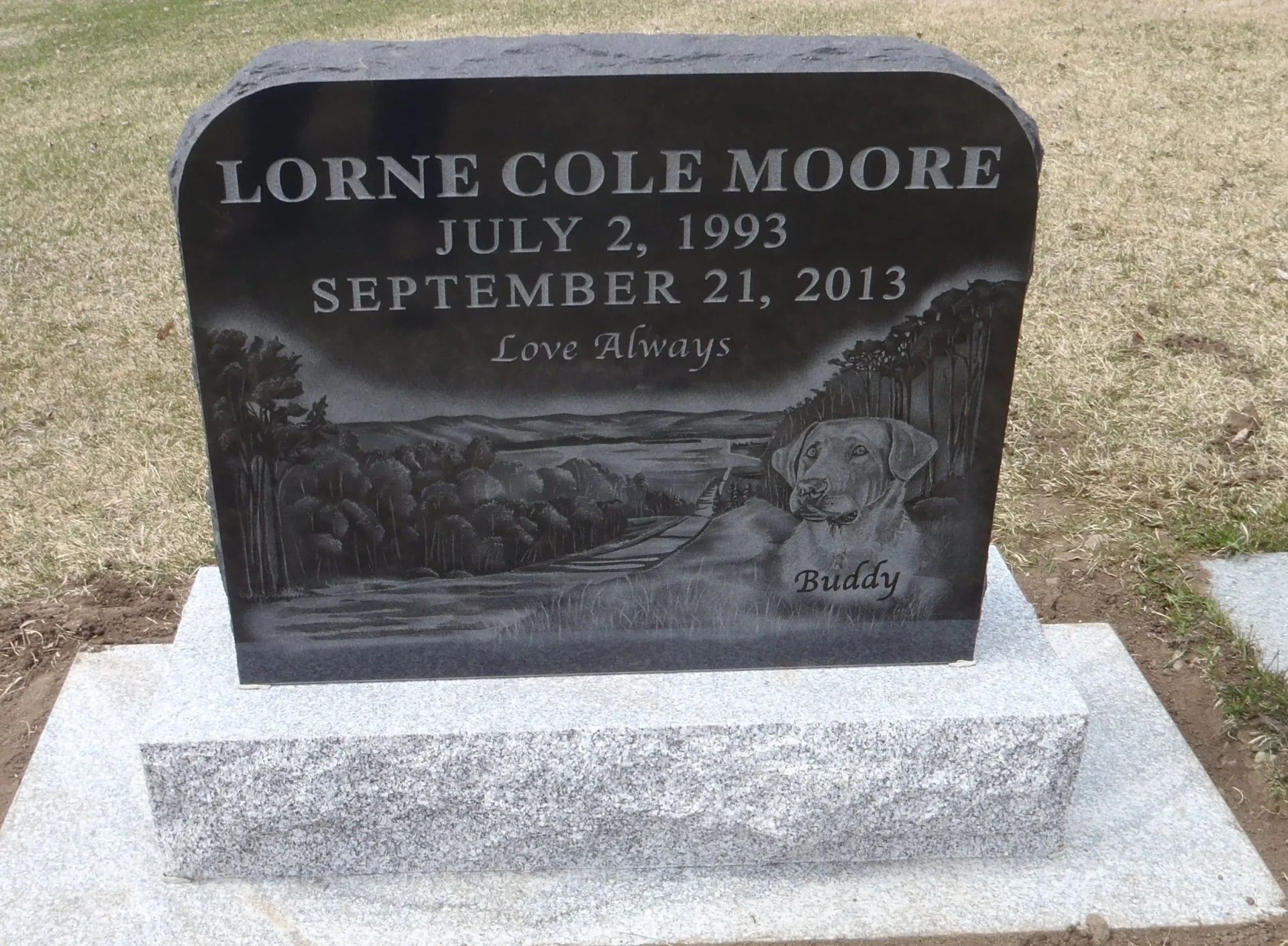 Gravestone for Lorne Cole Moore with engraved dates and “Love Always” in a cemetery.