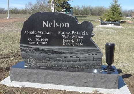 Black granite memorial headstone for Nelson and Patricia, with engraved names and dates in a cemetery.