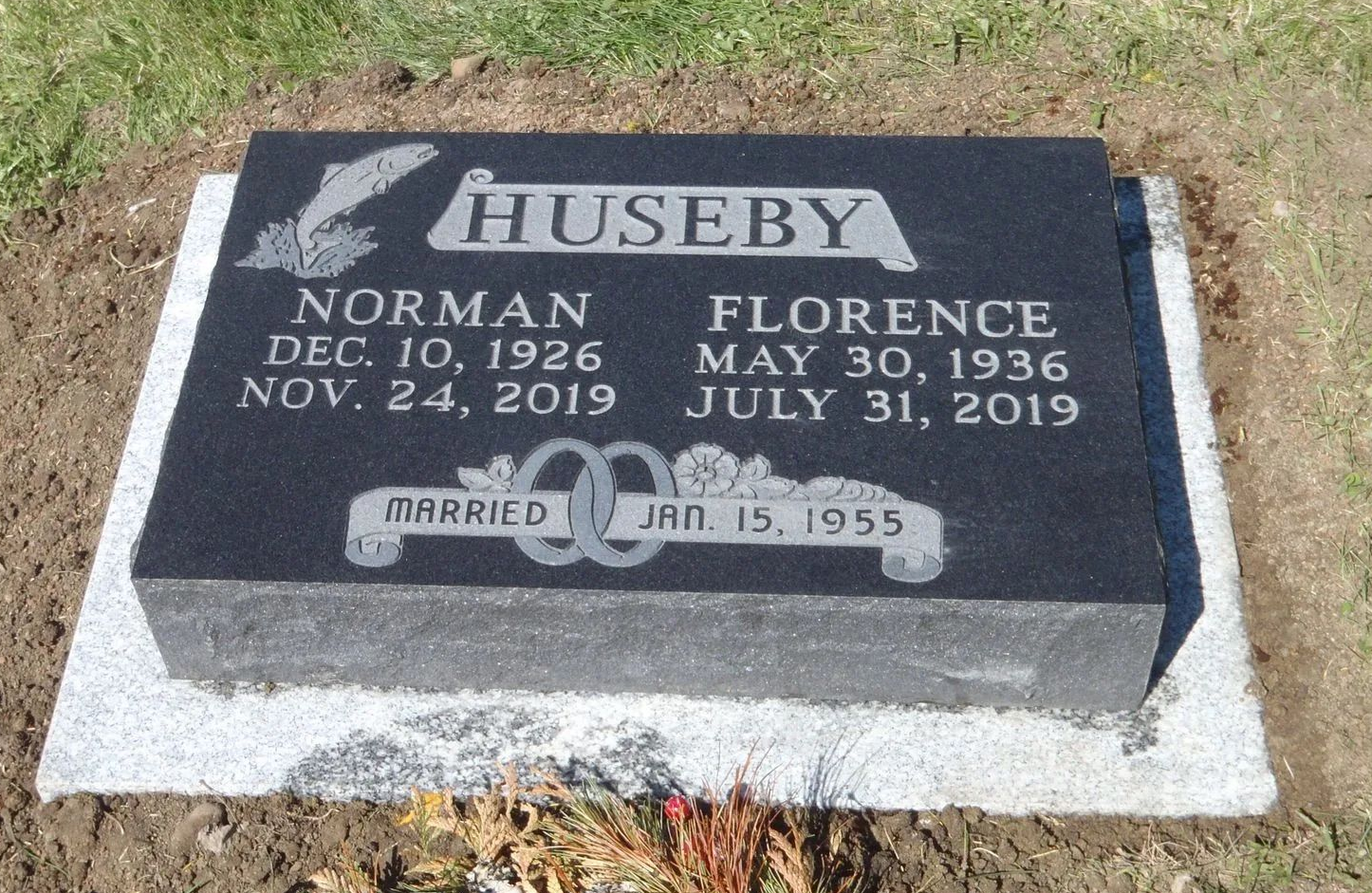 Black headstone with names Norman and Florence Huseby, birth and death dates, and marriage date