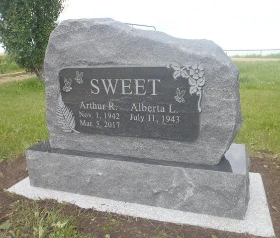 Gray gravestone with the name SWEET in a rural cemetery