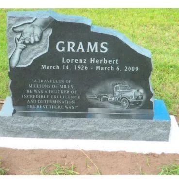 Gravestone with “GRAMS” and the names Lorenz Herbert and March 1926–March 6, 2009, on a lawn.