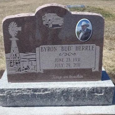Memorial gravestone with engraved truck, windmill, and oval portrait photo