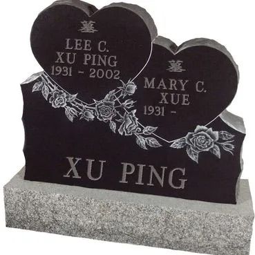 Two black heart-shaped gravestones with floral engraving and names Lee C. Xu Ping and Mary C. Xue on a gray base
