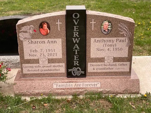Memorial gravestone with portraits, names Sharon Ann and Anthony Paul, and the word “OVERWHELMED” in center.