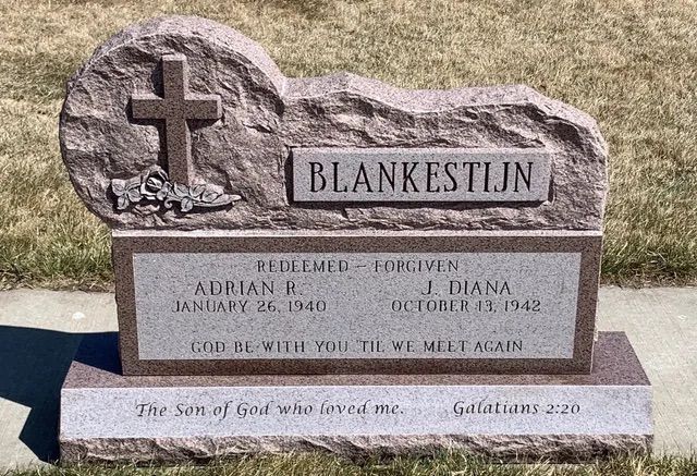 Brown granite memorial stone with cross and the name “Blankenstein” engraved.