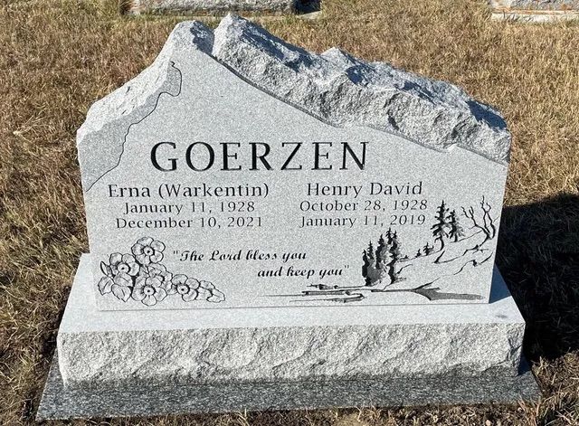 Gray gravestone with the surname Goerzen and engraved names in a dry cemetery setting.