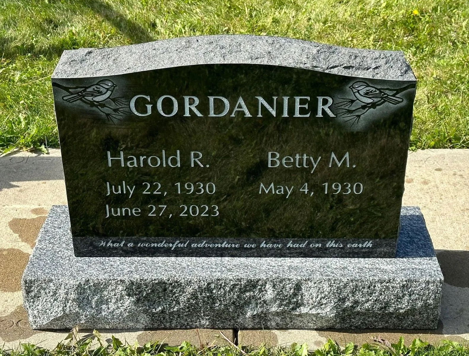 Granite memorial headstone reading “GORDANIER” with names Harold R. and Betty M. in a grassy cemetery