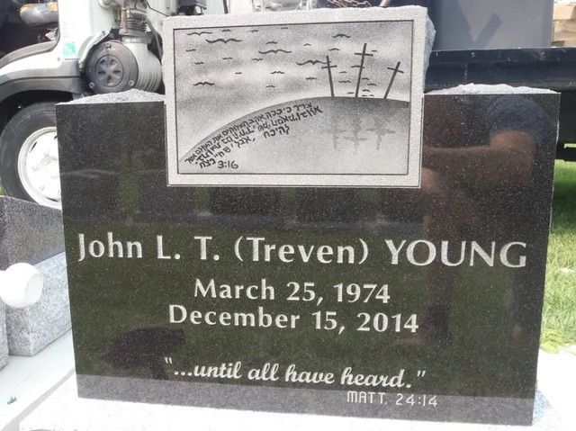 Black granite gravestone with photo and inscription for John L. T. (Treven) Young, March 25, 1974–Dec. 15, 2014