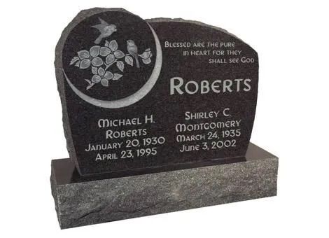 Black granite memorial headstone with floral engraving and the name Roberts engraved on the front.