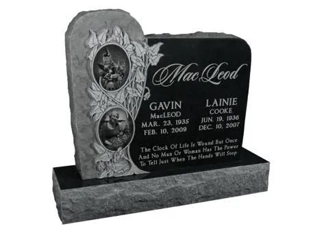 Black granite memorial headstone with engraved portraits, names, dates, and floral carving