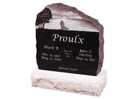 Black granite memorial stone with engraved beach scene and the name “Proulx” on a white base