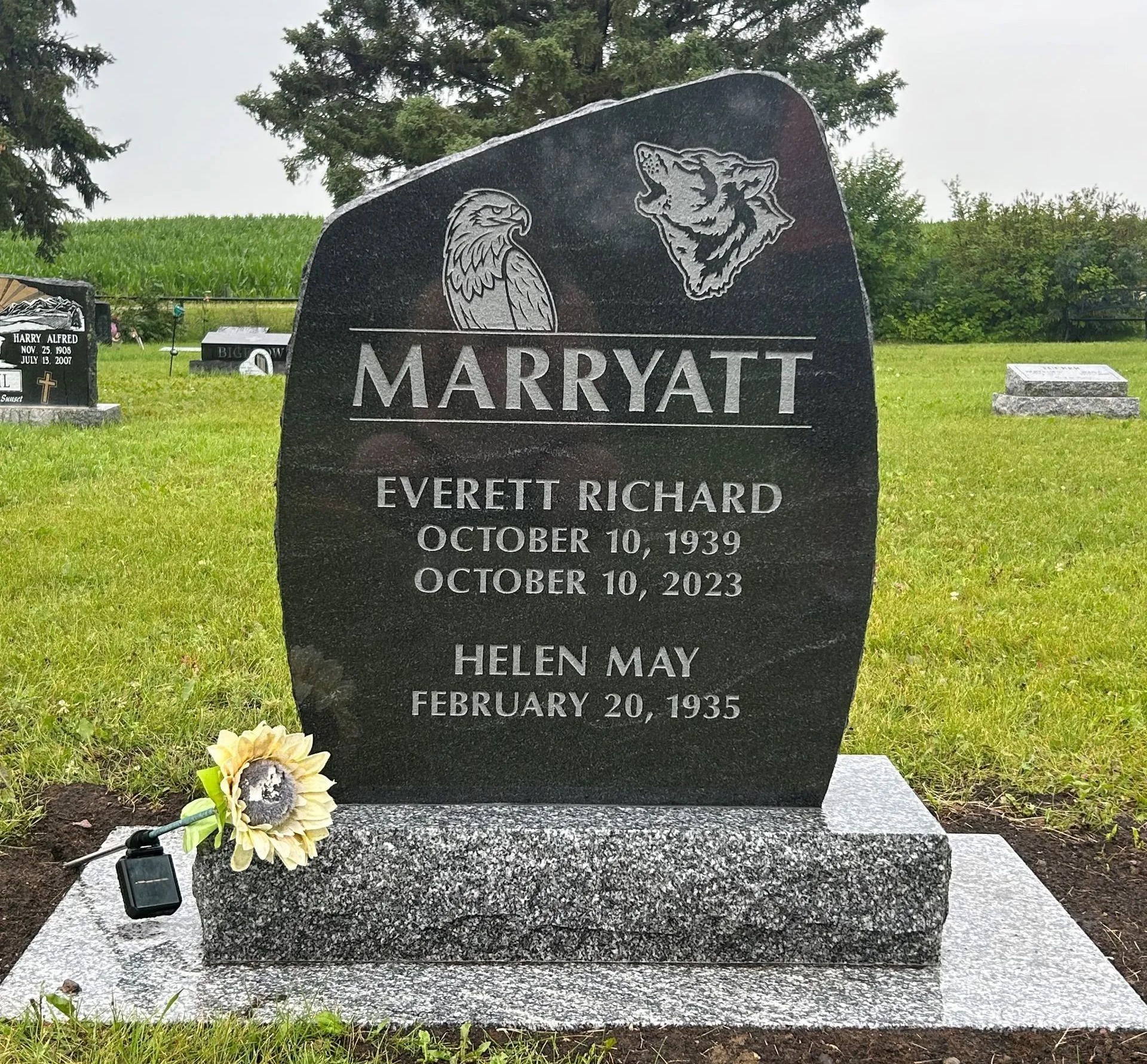Marryatt family gravestone in a green cemetery, with flowers at the base.