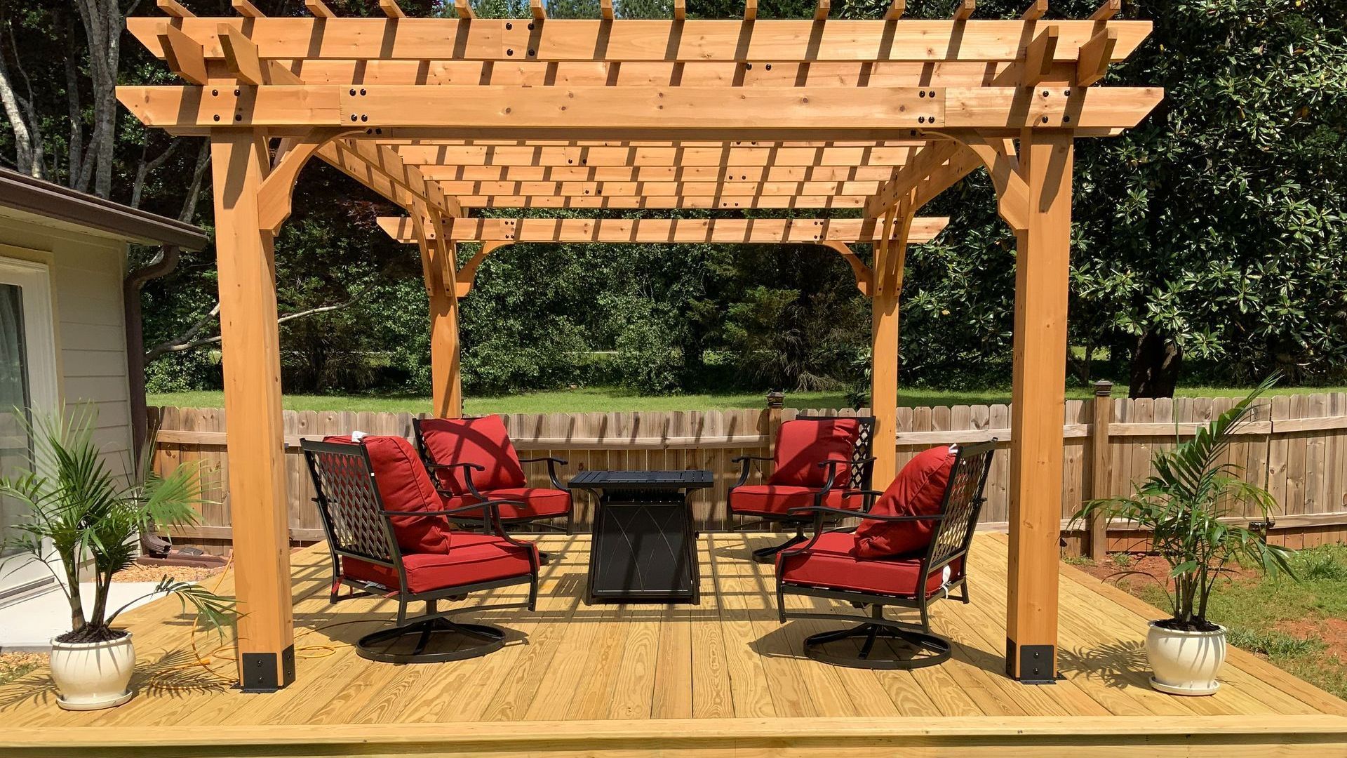 A beautiful wooden pergola with furniture and table
