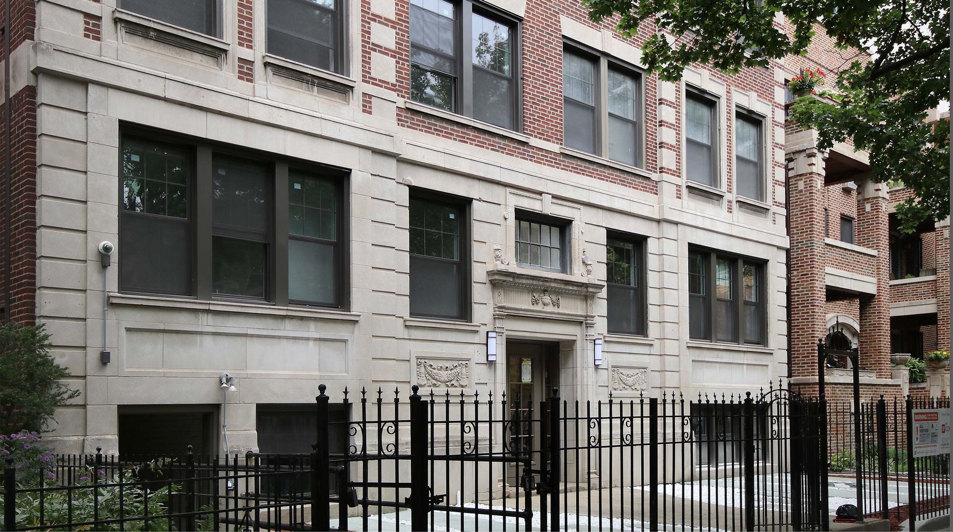 A large brick building with a fence around it