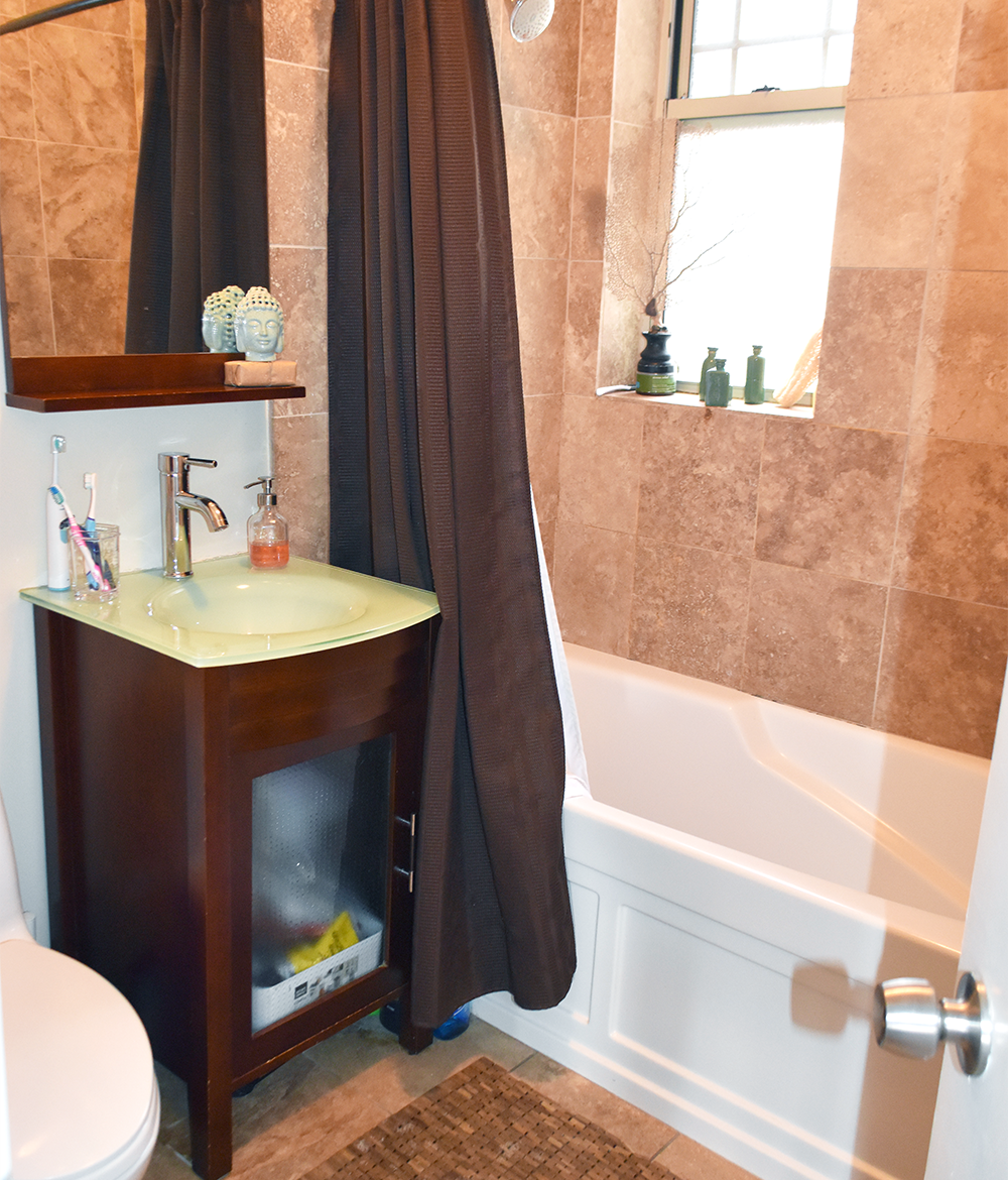 A bathroom with a sink a toilet and a tub