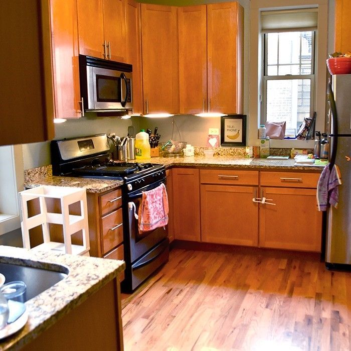 A kitchen with wooden cabinets and granite counter tops