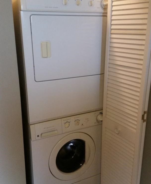 A washer and dryer are stacked on top of each other