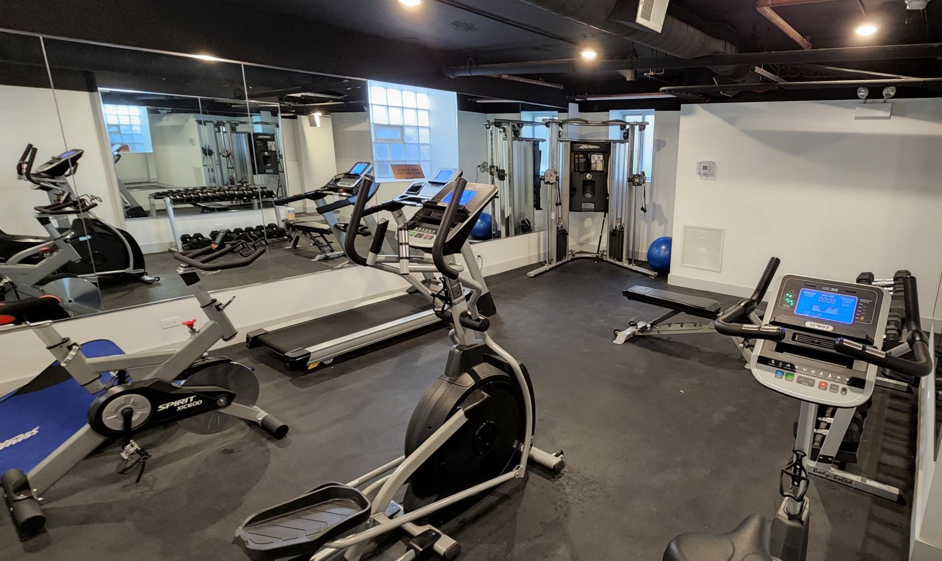 A gym filled with a variety of exercise equipment.