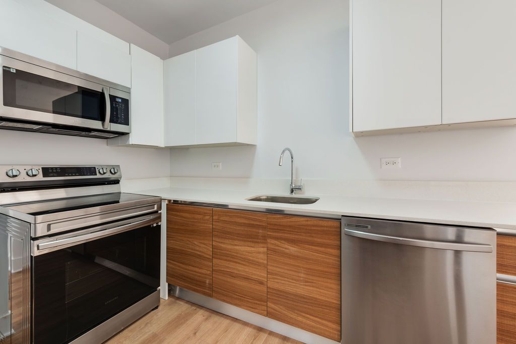 A kitchen with stainless steel appliances and wooden cabinets