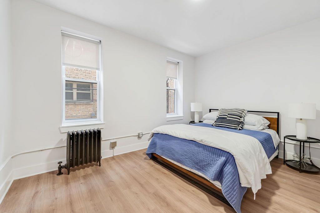 A bedroom with a large bed and a window.