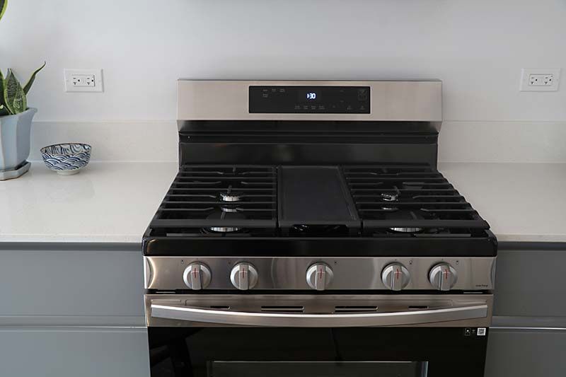 A stove top oven is sitting on top of a counter in a kitchen.