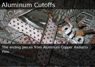 Aluminum cutoff scraps from radiator fins, silver pieces with red dots in a pile