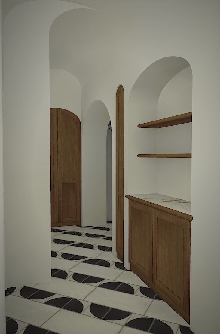 Narrow arched hallway with white walls, wood cabinetry, and black-and-white patterned floor tiles.