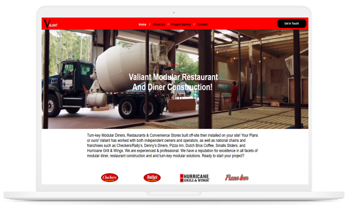 A laptop screen shows a concrete mixer truck on a construction site