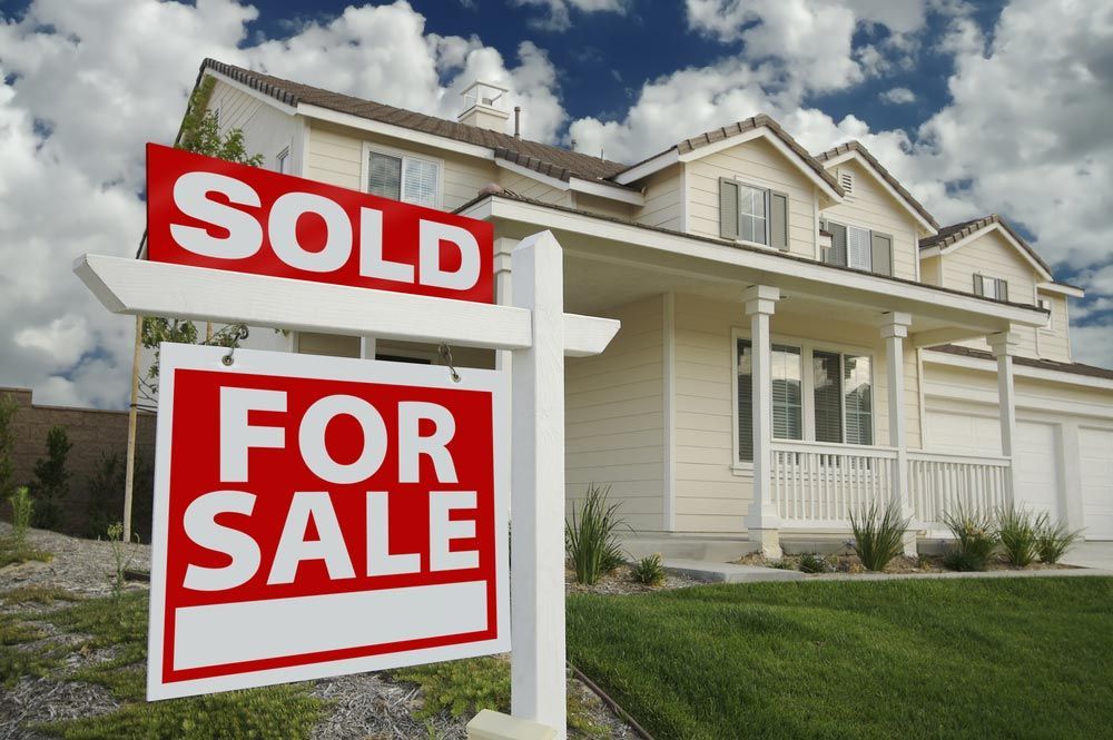 A House With a Sold for Sale Sign in Front of It — Cairns Property Collective in Kanimbla, QLD