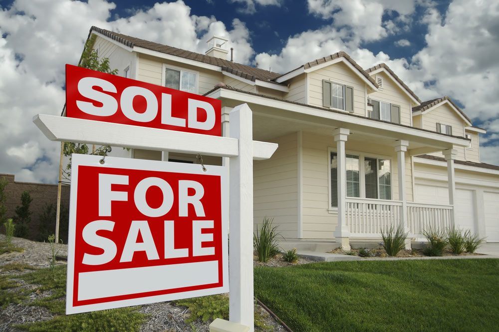 A House With a Sold for Sale Sign in Front of It — Cairns Property Collective in Brinsmead, QLD