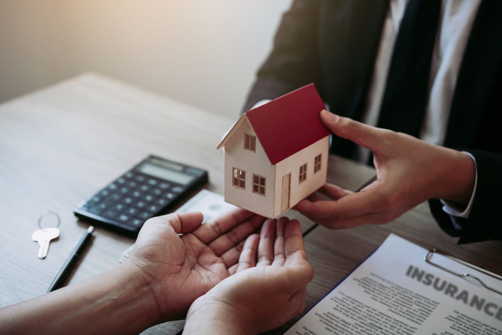A Person Is Holding a Model House in Their Hands — Cairns Property Collective in Trinity Park, QLD
