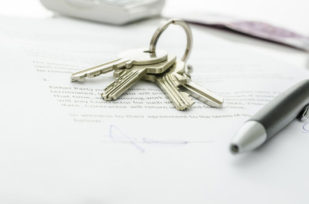 A Pen is Sitting on a Piece of Paper Next to a Bunch of Keys — Cairns Property Collective in Bentley Park, QLD