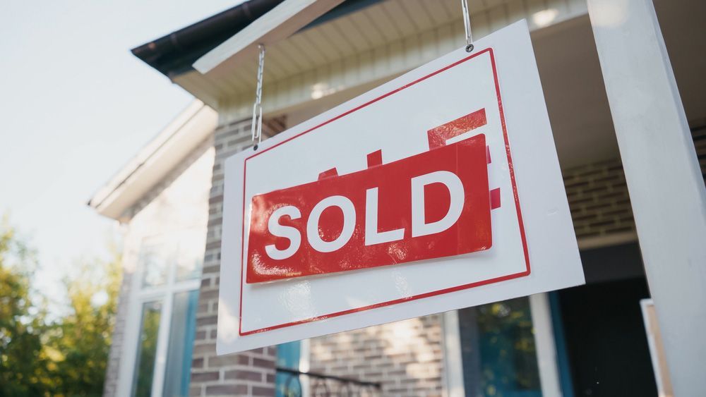 A Sold Sign is Hanging on the Front of a House — Cairns Property Collective in Bentley Park, QLD