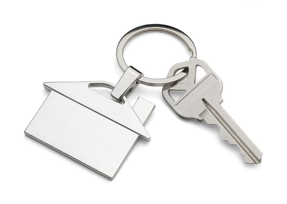 A Key with A House Keychain Attached to It — Cairns Property Collective in Trinity Park, QLD