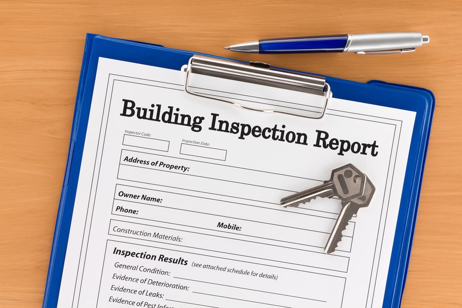 A Clipboard with A Building Inspection Report and Keys on It — Cairns Property Collective in Edmonton, QLD