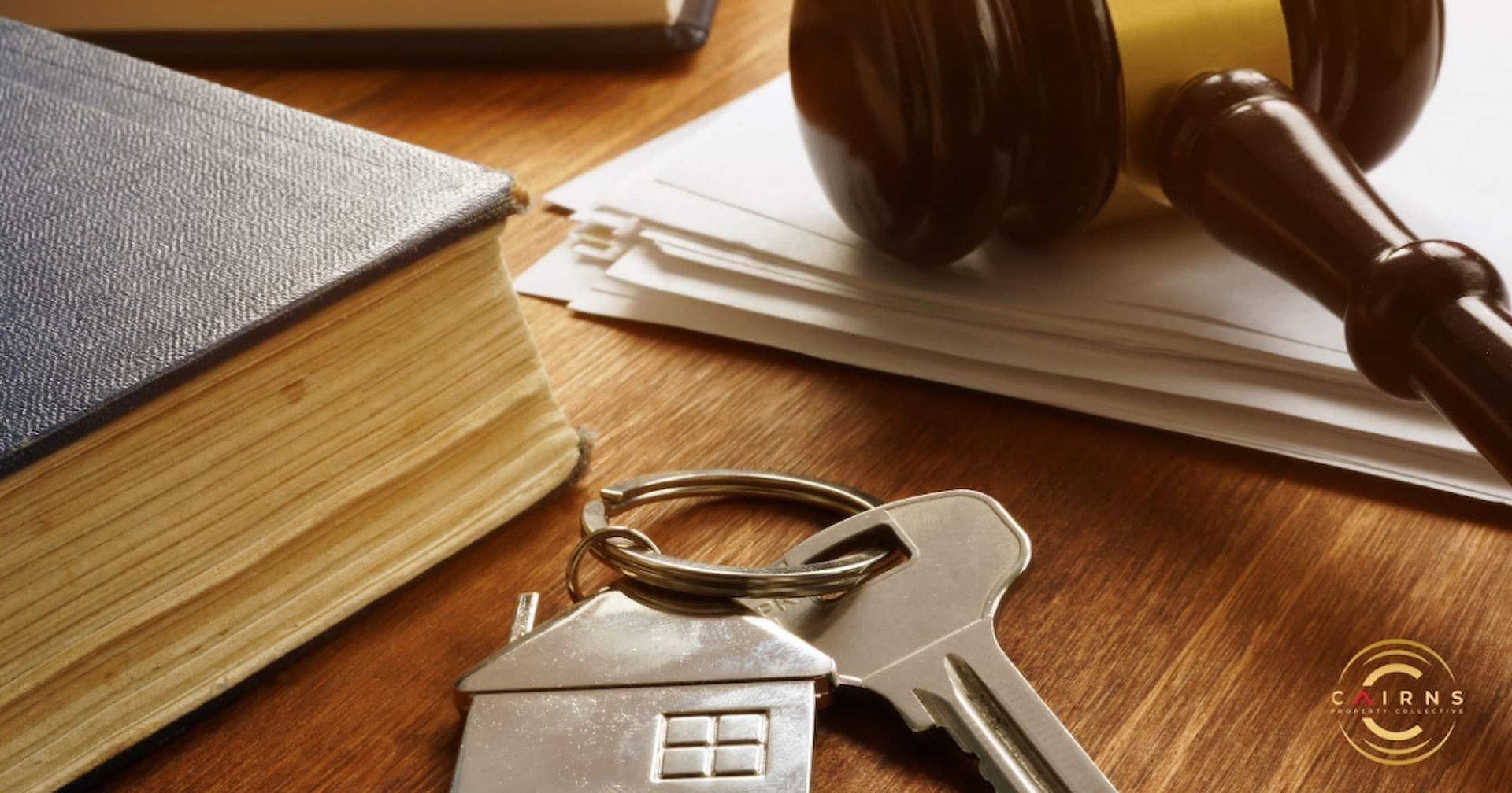 A Pair of Keys Sitting on Top of A Wooden Table — Cairns Property Collective in Trinity Park, QLD