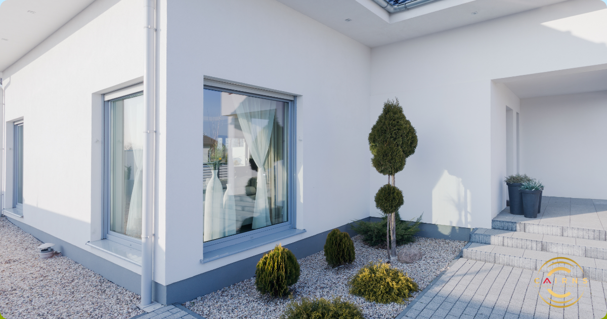 Minimalist landscape image with well manicured bushes and pebbles in the garden.