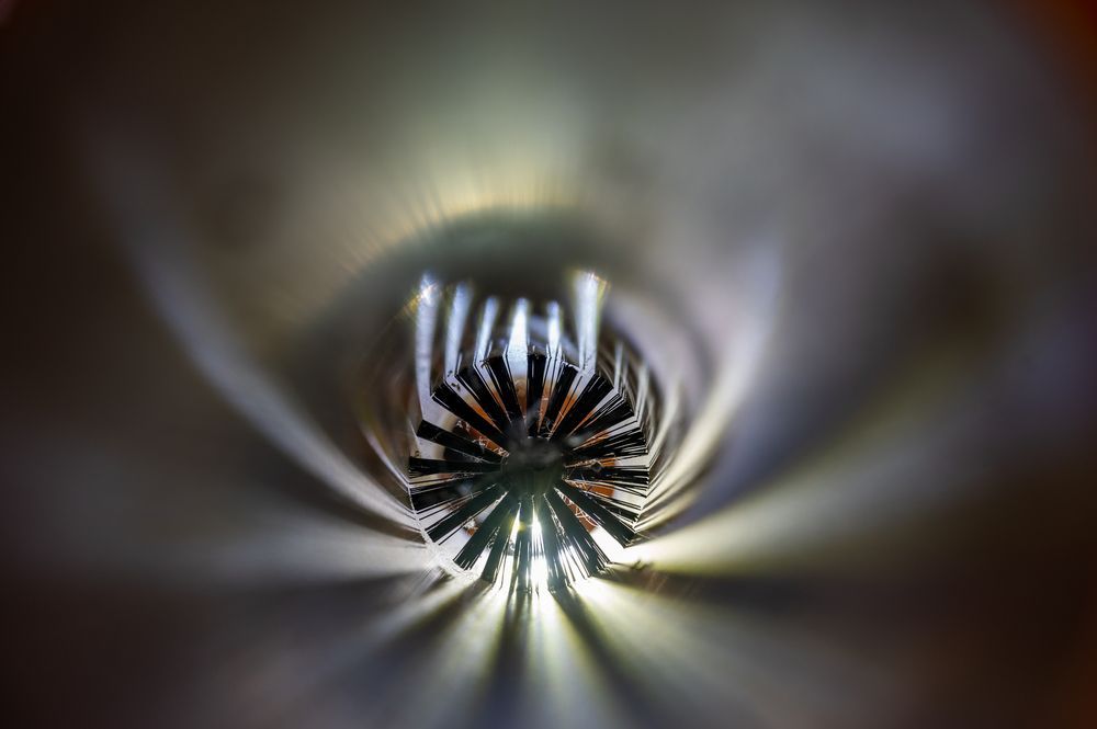 A close up of a light coming out of a pipe.