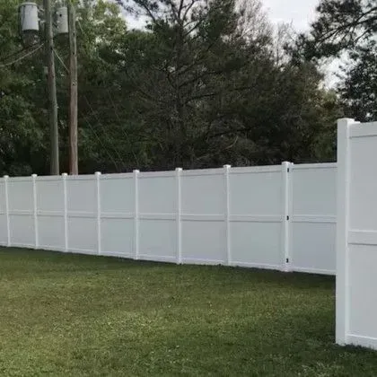 Wood fence beside a walkway and screened pool enclosure