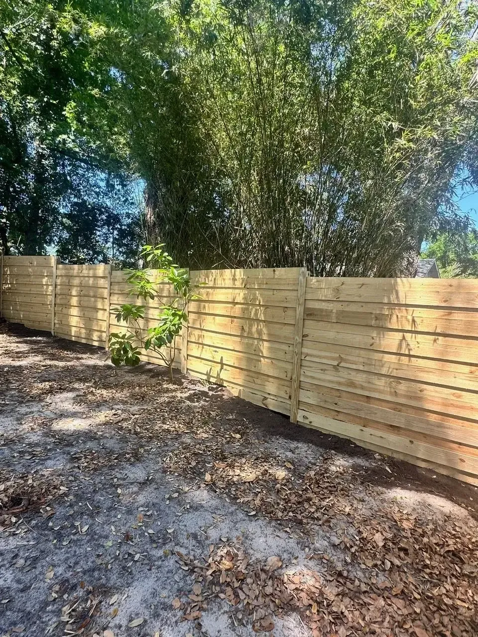 Wood privacy fence stepped down a sloped residential yard