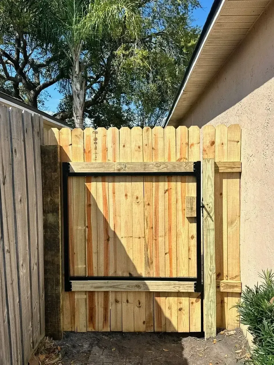 Wood fence gate with a steel frame at an Atlantic Beach property