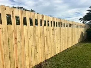 Shadowbox-style wood fence along the rear of a residential backyard
