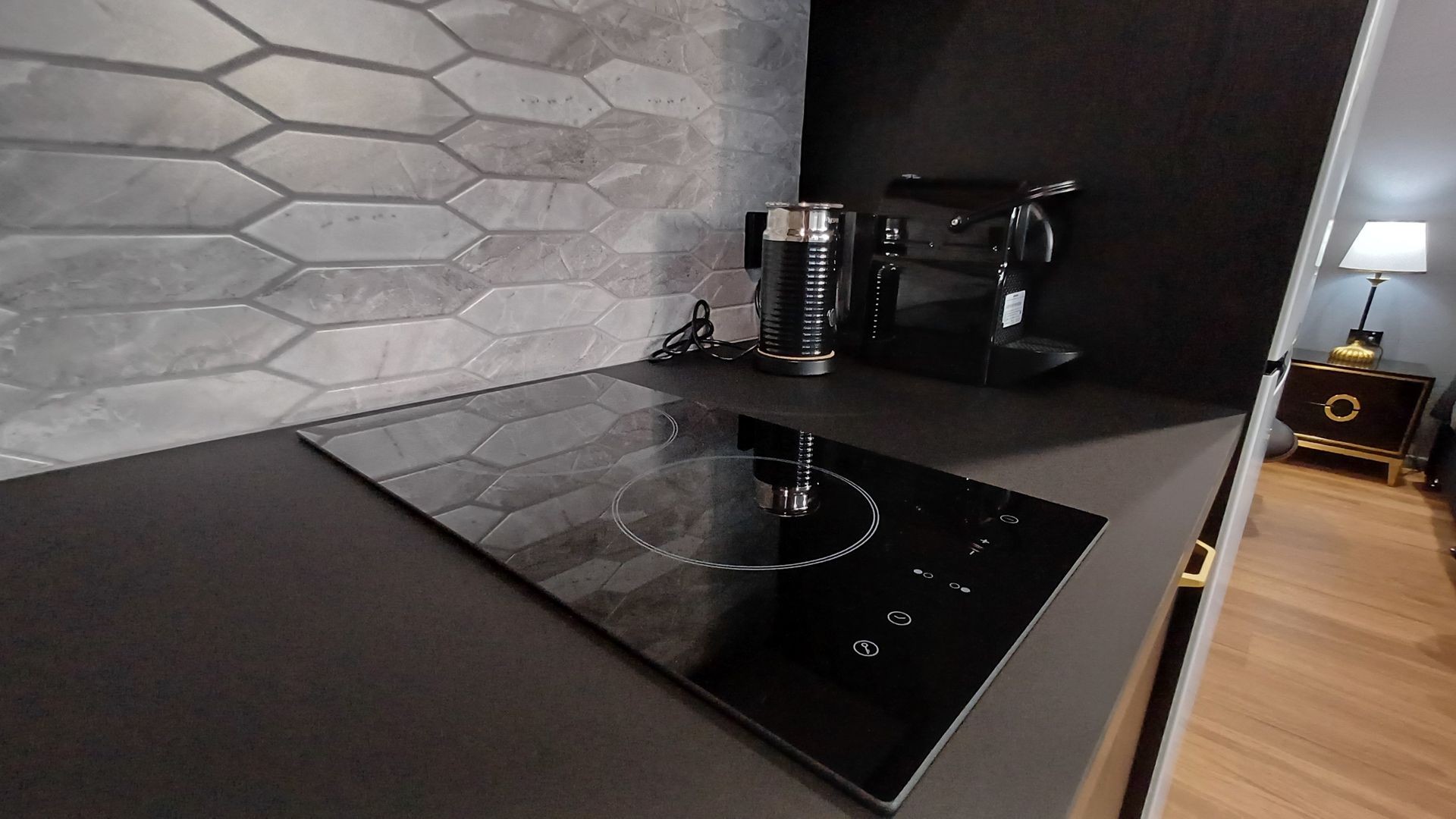 Modern Kitchen Countertop With Black Induction Cooktop — Green Valley Electrical in Alstonville, NSW